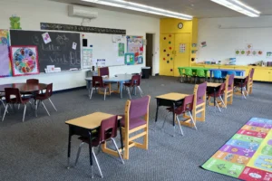 Hand in Hand ABA classroom with chalkboard, letter of the week display and group tables